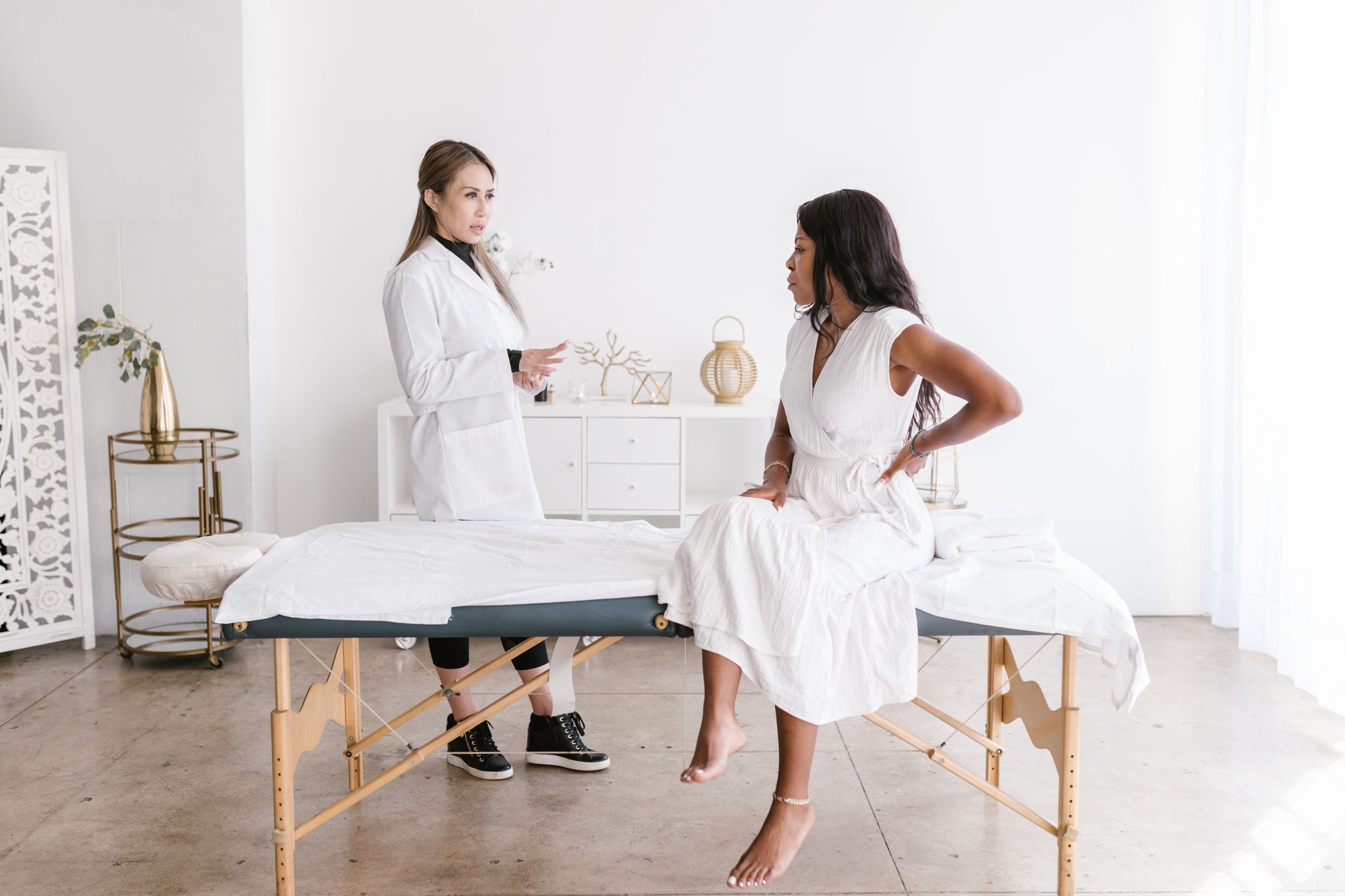 A doctor consulting a patient in a well-lit modern office setting.